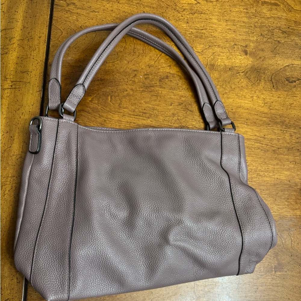 100 percent leather Over earth purple tint and  brown tint  bag. Great condition